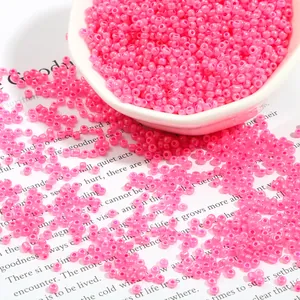 Rose pink 450g glass seed beads for DIY jewelry making in a white ceramic bowl