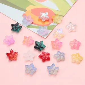 Macro detail of colorful gradient glass flower beads with iridescent finish for DIY crafts
