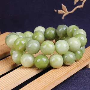 Macro detail of natural green jade round beads showing smooth texture and inner patterns