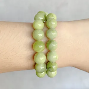 Polished light green natural jade round bead bracelet set with smooth waxy texture