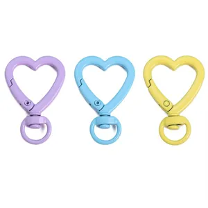 Colorful heart-shaped spring alloy keychains in purple, blue, and yellow finishes