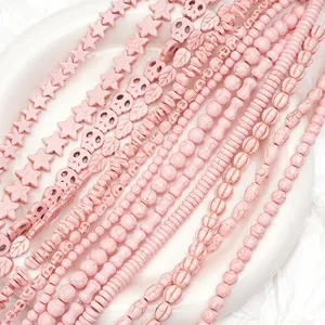Close-up of pink synthetic turquoise beads in various shapes including stars and skulls