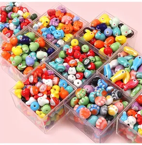 Close-up of colorful ceramic animal beads in storage boxes for DIY jewelry making