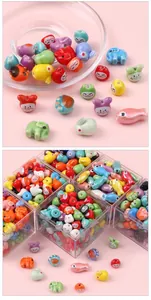 Close-up of assorted ceramic animal beads in a storage box for DIY jewelry making