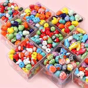 Colorful animal ceramic beads for DIY jewelry making stored in organized clear boxes
