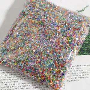Macro view of 2mm colorful glass bugle beads in bulk packaging for DIY jewelry making