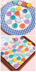 Macro shot of 20mm round acrylic smiley face beads in various macaron colors