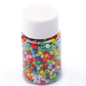 Colorful assorted glass seed beads set in clear plastic bottle for DIY jewelry making