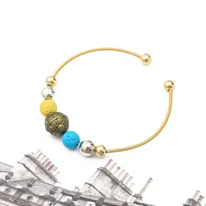 Bohemian open bangle bracelet with gold and silver beads and volcanic stone accents