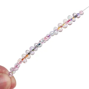 Detailed view of iridescent teardrop glass beads with rainbow finish for DIY jewelry