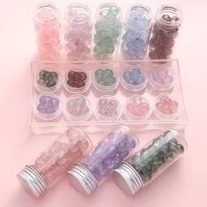 Macro detail of colorful 10mm frosted glass beads stored in transparent mini containers