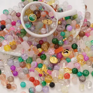 Macro shot of colorful mixed glass beads and alloy charms for DIY jewelry making