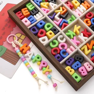 Macro view of colorful acrylic alphabet beads and a DIY handmade HAPPY keychain