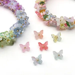 Macro detail of macaron butterfly and floral beads with golden metallic accents