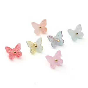 Detailed macro view of colorful glass butterfly pendants with glitter finish for DIY jewelry