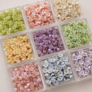 Detailed view of lily of the valley resin flower charms in assorted pastel colors