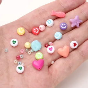Macro shot of 15-grid colorful mixed shapes heart shell starfish beads for DIY jewelry