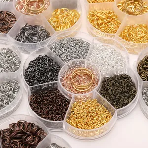 Close-up of assorted colorful metal jump rings in a floral plastic organizer box