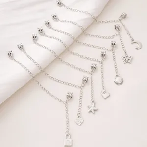 Silver plated DIY charms bracelet with heart and star pendants on white background