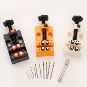 Close-up of mini ABS plastic drill press vice with twist bits and manual hand drill tool