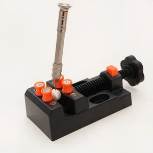 Mini drill press vise securing a pearl for precision hand drilling and jewelry making