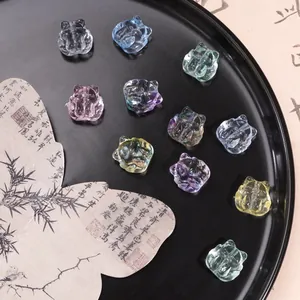 Macro detail of multicolored 18mm glass fox beads arranged on a black decorative plate