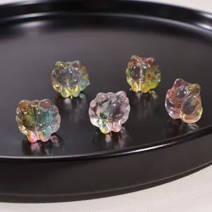 Macro shot of five iridescent glass nine-tailed fox beads with colorful AB coating finish