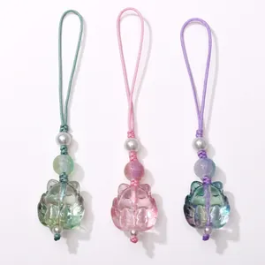 Three translucent glass cat charms for DIY crafts in green, pink, and purple colors