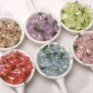 Close-up of colorful iridescent acrylic lily flower pendants with pearls for DIY jewelry