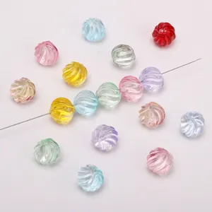 Macro detail of 12mm multi-colored ribbed glass pumpkin beads for DIY jewelry making