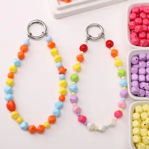 Close-up of colorful 8mm acrylic faceted square beads with silver spring ring clasps