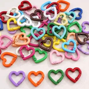 Close-up of heart-shaped spring buckles in various colorful spray-painted alloy finishes