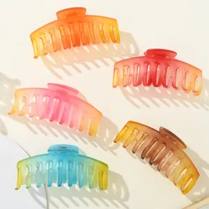 Detailed top view of large matte gradient shark hair clips in five vibrant colorways