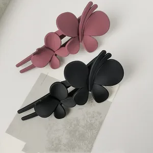 Matte butterfly hair clip set in black and dusty pink for elegant hairstyling