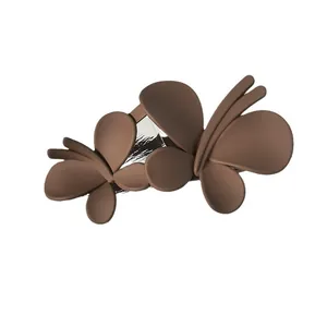 Elegant matte brown double butterfly hair claw clip for bun hairstyles on white background