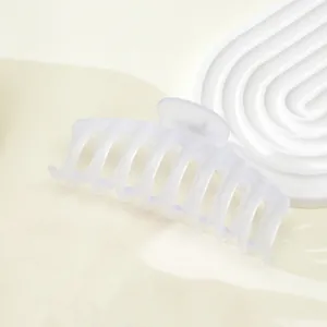 Close-up of a large 11cm frosted translucent hair claw clip with cross comb teeth