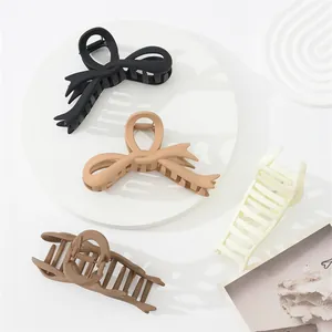 Elegant matte bow hair claw clips for women in assorted minimalist earth tones