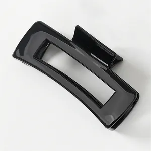 Macro shot of rectangular hollow hair claw clip in glossy black resin finish