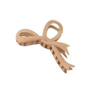 Elegant matte beige ribbon bow hair claw clip for women with a minimalist resin design