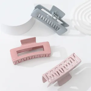 Glossy macaron square hair claw clips in grey, mauve and pink colors on white podiums