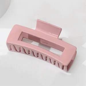 Detailed view of large macaron pink rectangular hair claw clip with cutout design