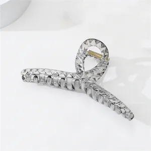 Detailed macro view of gray transparent hair claw clip with diamond pattern texture