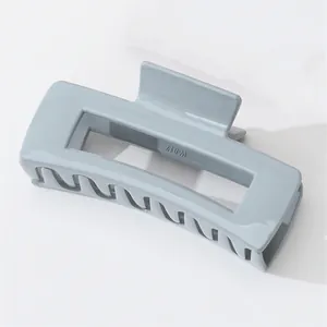 Detail shot of the glossy blue rectangle hair claw clip with interlaced teeth