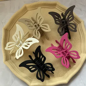 Set of five hollow butterfly hair claws in matte resin with neutral and bright colors