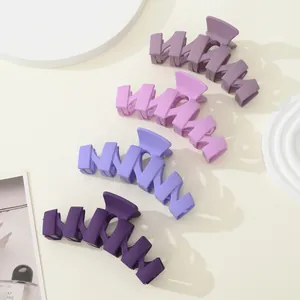 Set of four matte purple wavy hair claw clips for women with non-slip grip design
