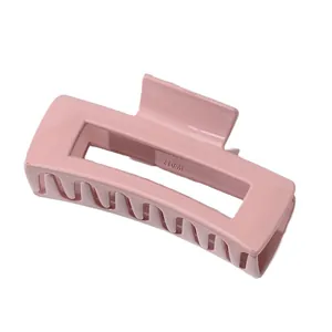 Glossy pink rectangular hair claw clip with cutout design and secure grip teeth