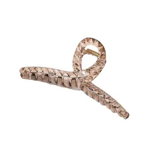 Elegant amber hair claw clip with geometric diamond cut texture and gold spring