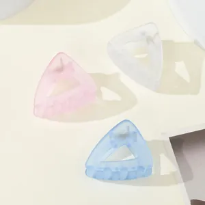 Three-piece matte hair claw set in pink, white, and blue with triangular hollow design