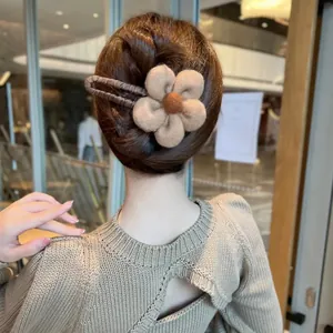 Rückansicht einer Frau mit weicher Plüsch-Blumen-Haarspange in Khaki bei Hochsteckfrisur