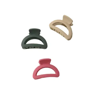 Three-piece set of mini matte claw clips in green, beige, and pink with metal springs